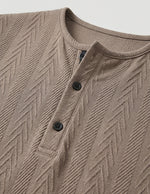 Close-up of a brown textured shirt with buttons on a light gray background