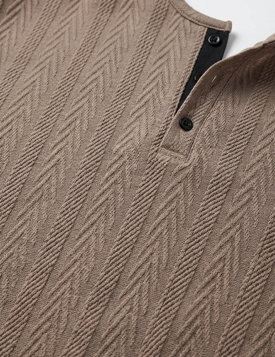 Close-up of a brown textured sweater with a patterned design.