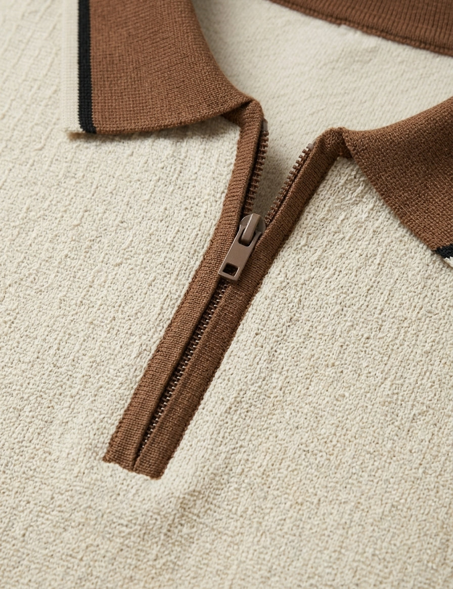 Close-up of a brown zipper on a textured beige surface