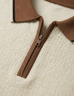 Close-up of a brown zipper on a textured beige surface