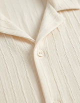 Close-up of a cream-colored shirt with buttons