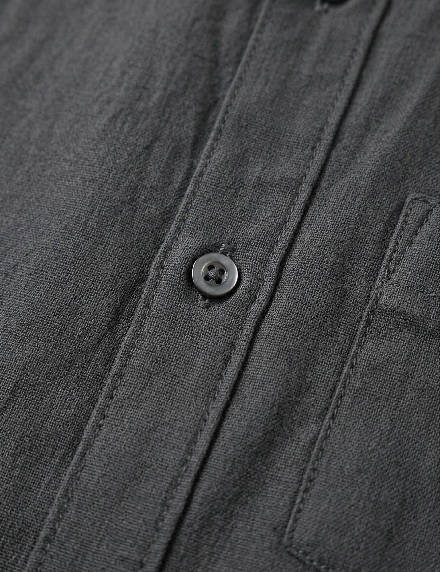 Close-up of a dark gray shirt with button details