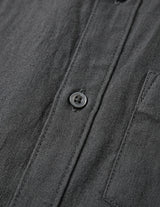 Close-up of a dark gray shirt with button details