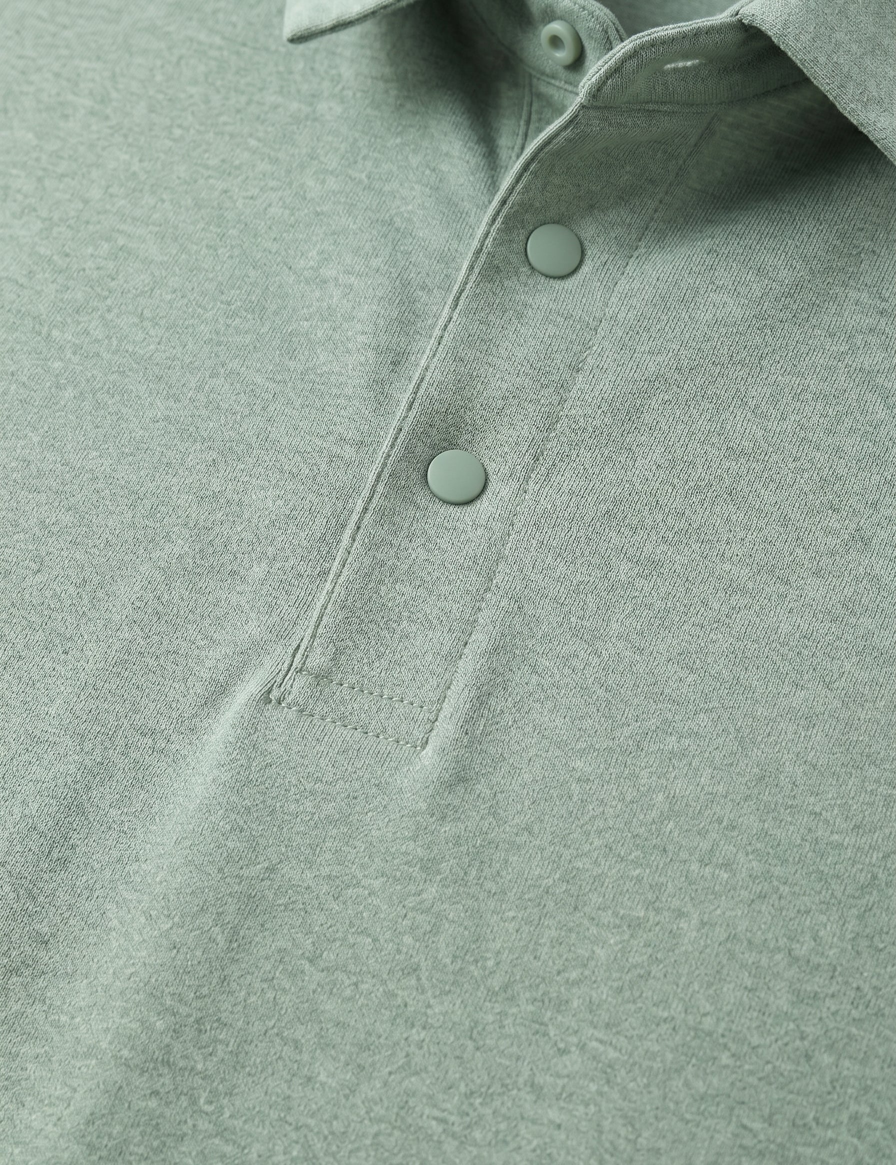 Close-up of a green polo shirt with buttons