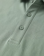 Close-up of a green polo shirt with buttons
