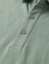 Close-up of a green polo shirt with buttons