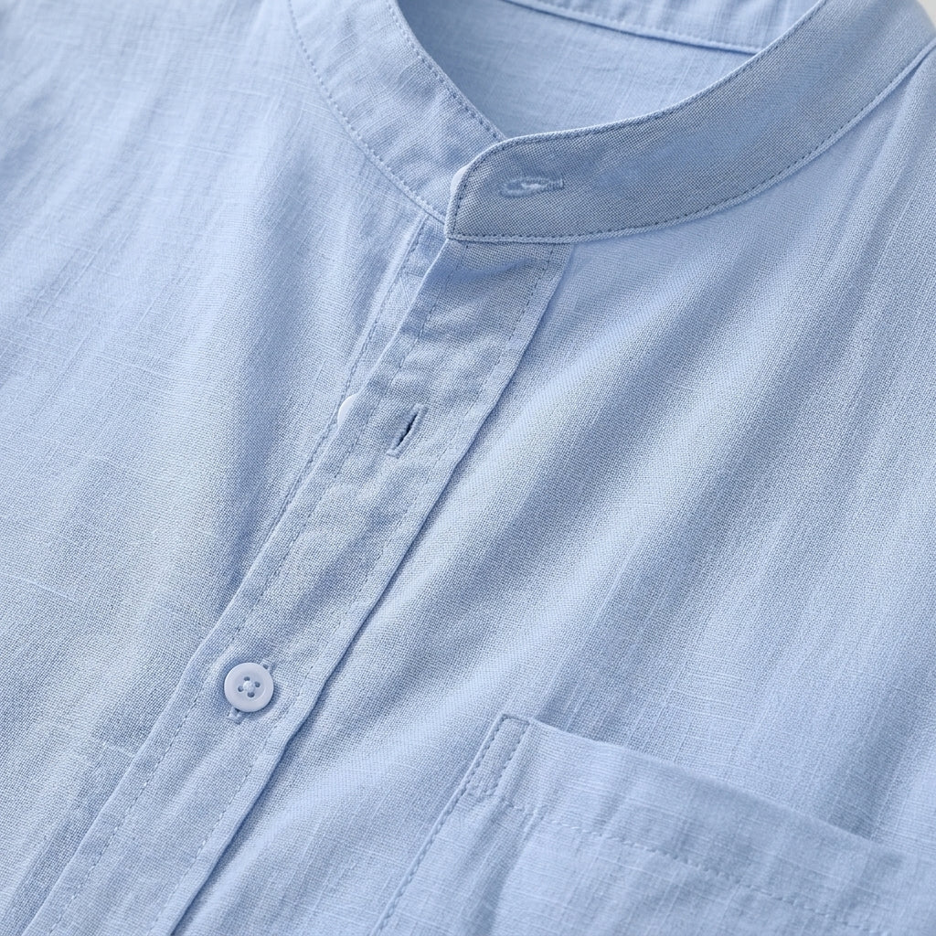 Close-up of a light blue shirt with a collar and button details.