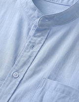 Close-up of a light blue shirt with a collar and button details.