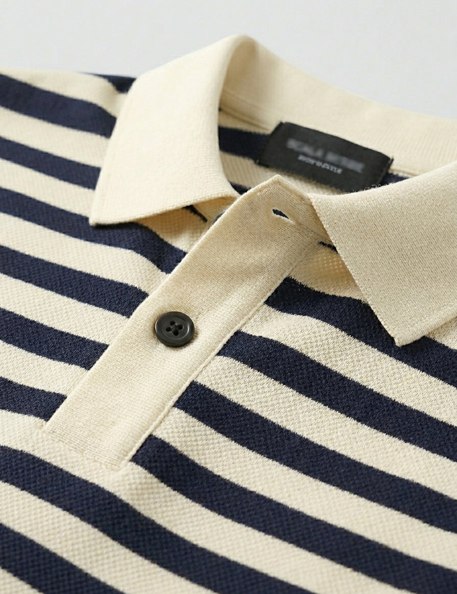Close-up of a navy and white striped polo shirt with a brand label.