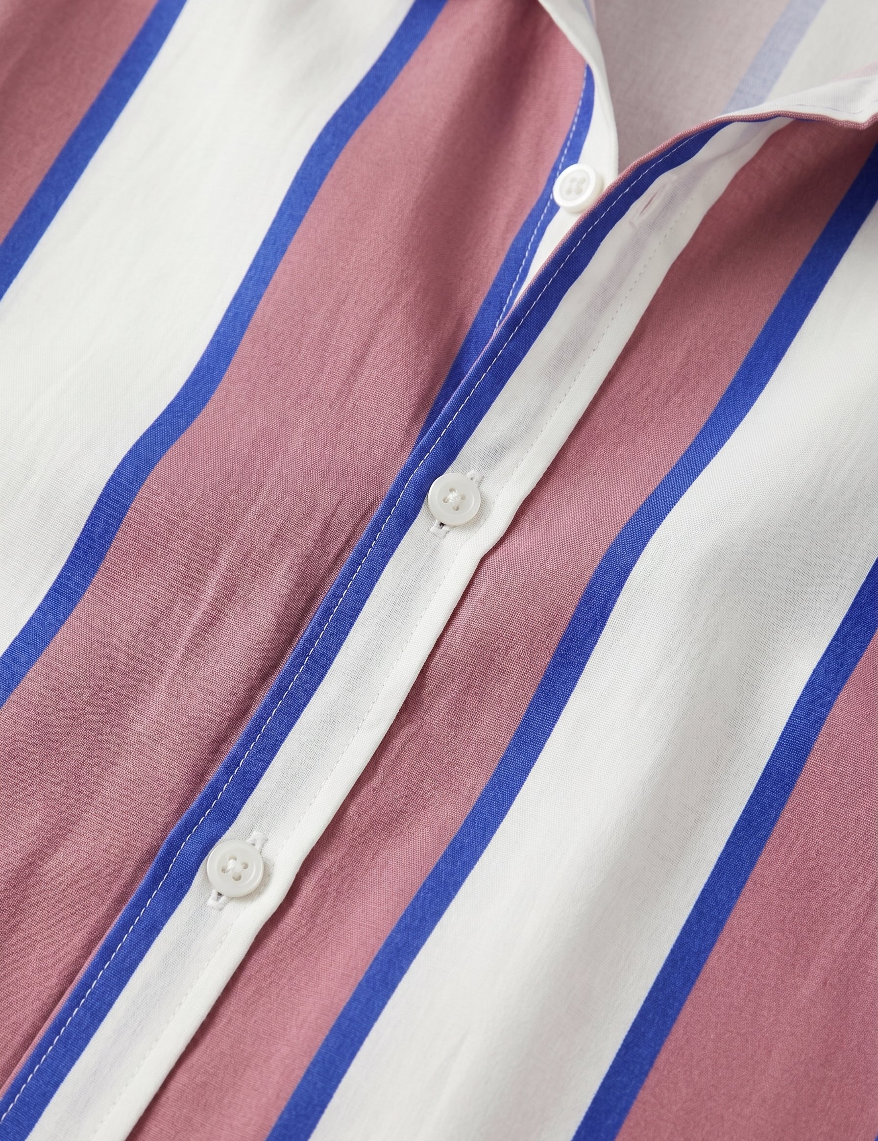Close-up of a striped shirt with pink, white, and blue horizontal stripes.