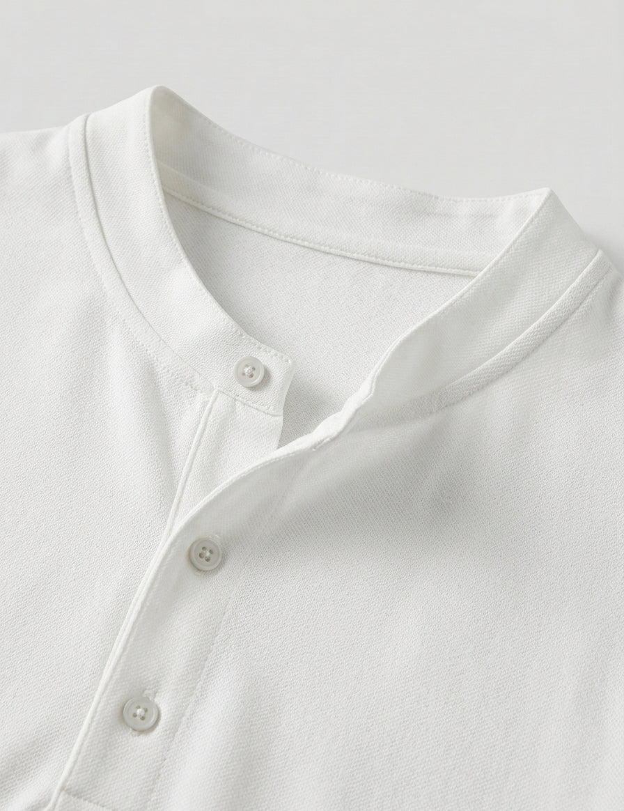 Close-up of a white shirt with buttons on a light gray background