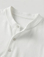 Close-up of a white shirt with buttons on a light gray background