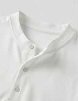 Close-up of a white shirt with buttons on a light gray background