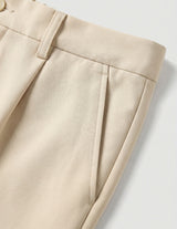 Close-up of beige pants on a light gray background