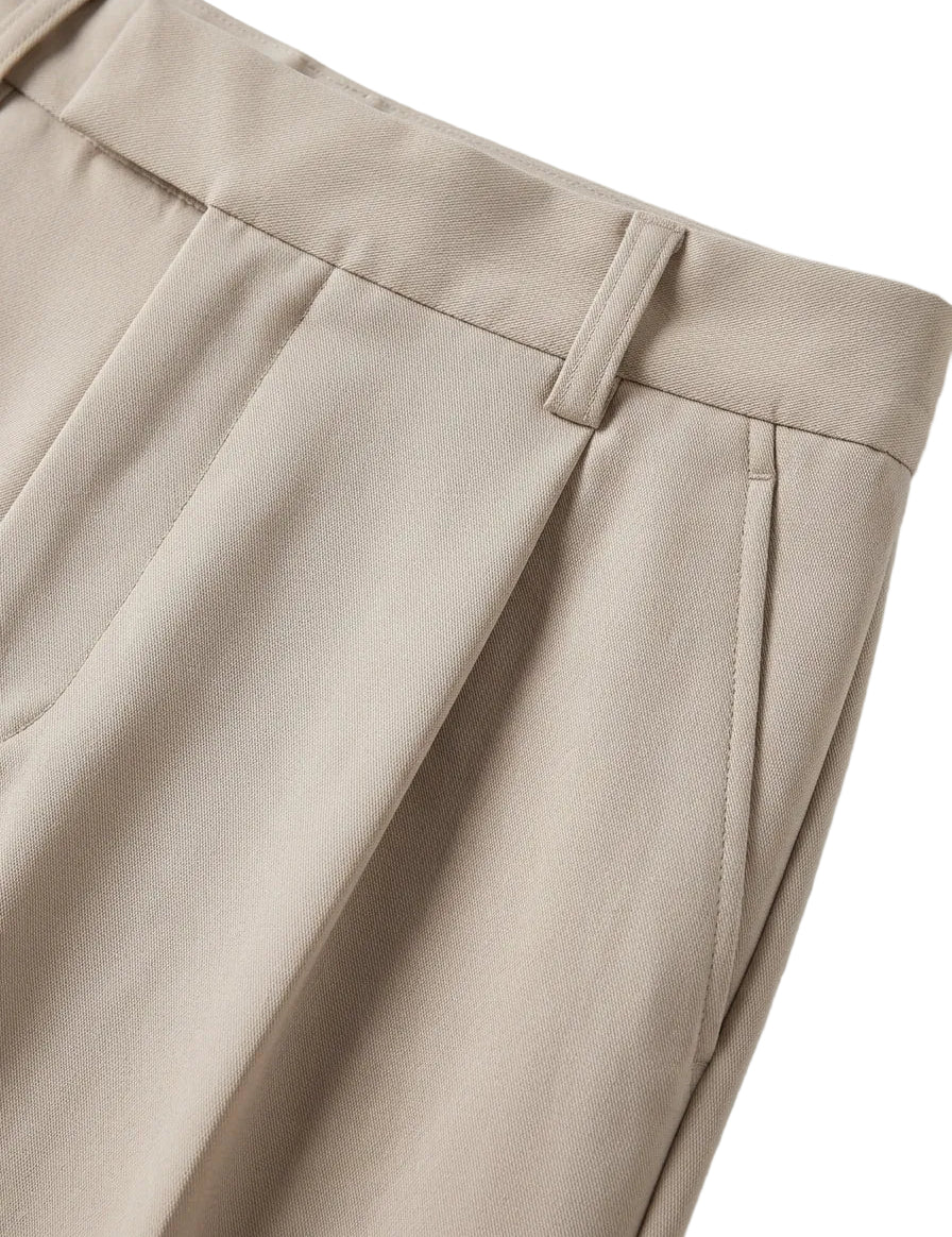 Close-up of beige pants on a light gray background