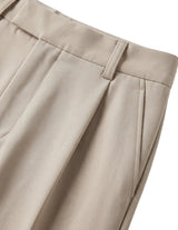 Close-up of beige pants on a light gray background