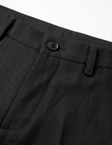 Close-up of black pants with a button on a white background