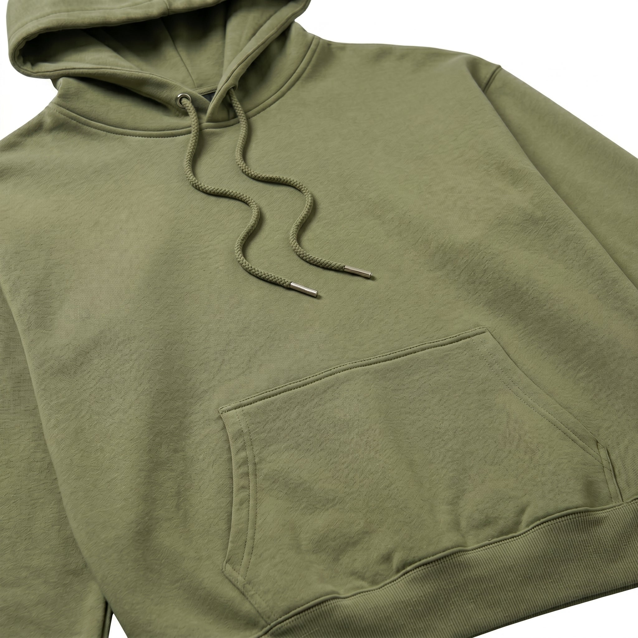 Close-up of male model wearing olive green jogger pants with a relaxed fit.