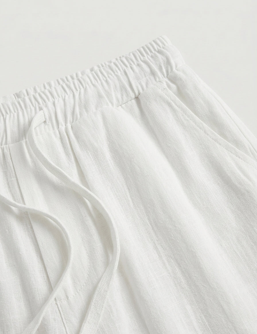 Close-up of white fabric with frayed edges on a light gray background