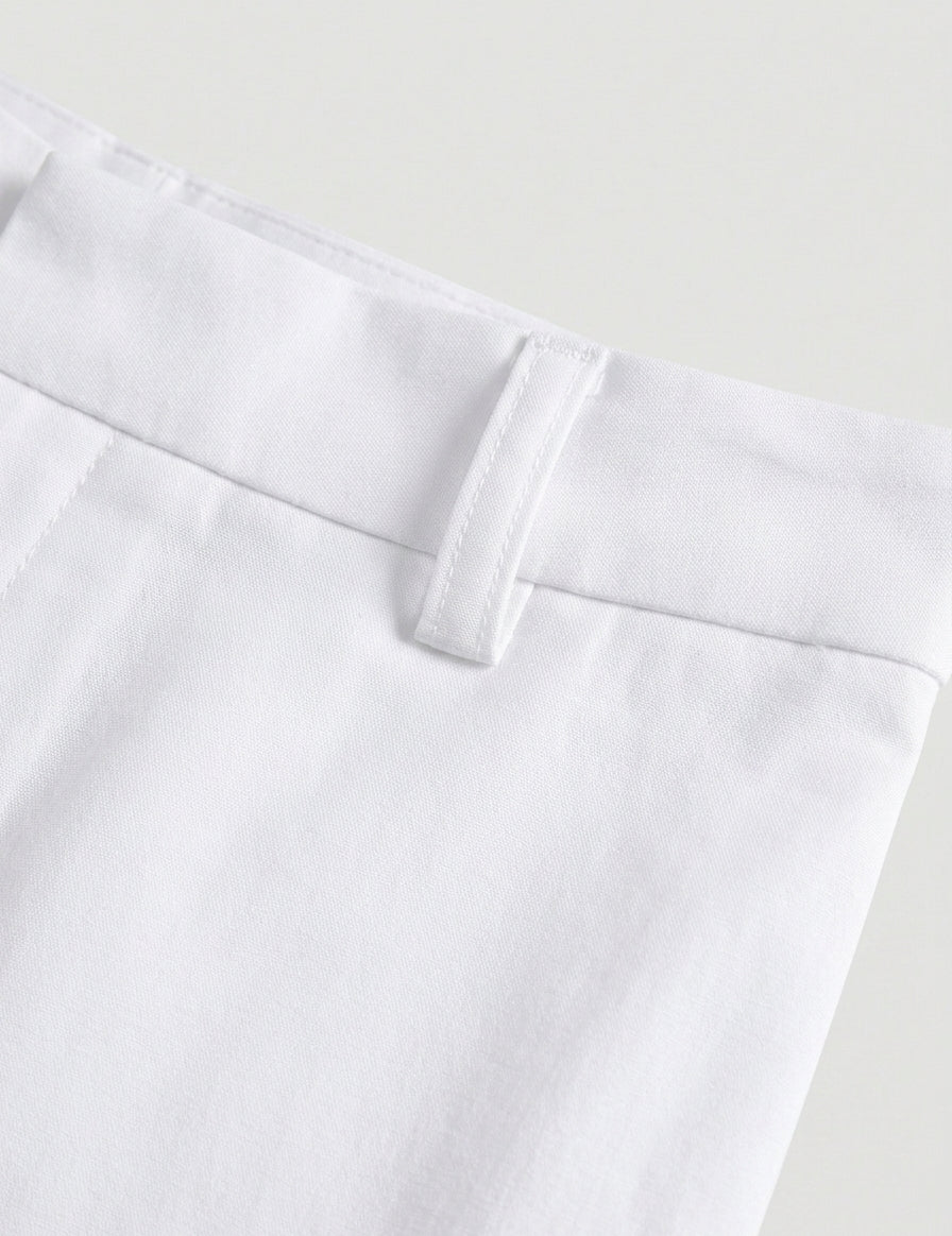 Close-up of white pants with a plain background