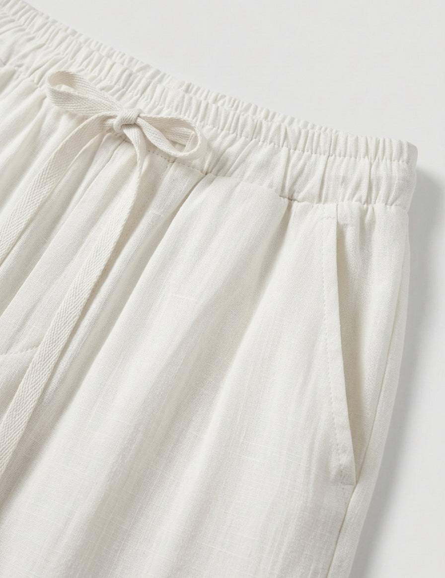 Close-up of white pants with an elastic waistband on a light gray background