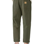 Close-up view of olive green jogger pants styled with a beige T-shirt and sneakers.
