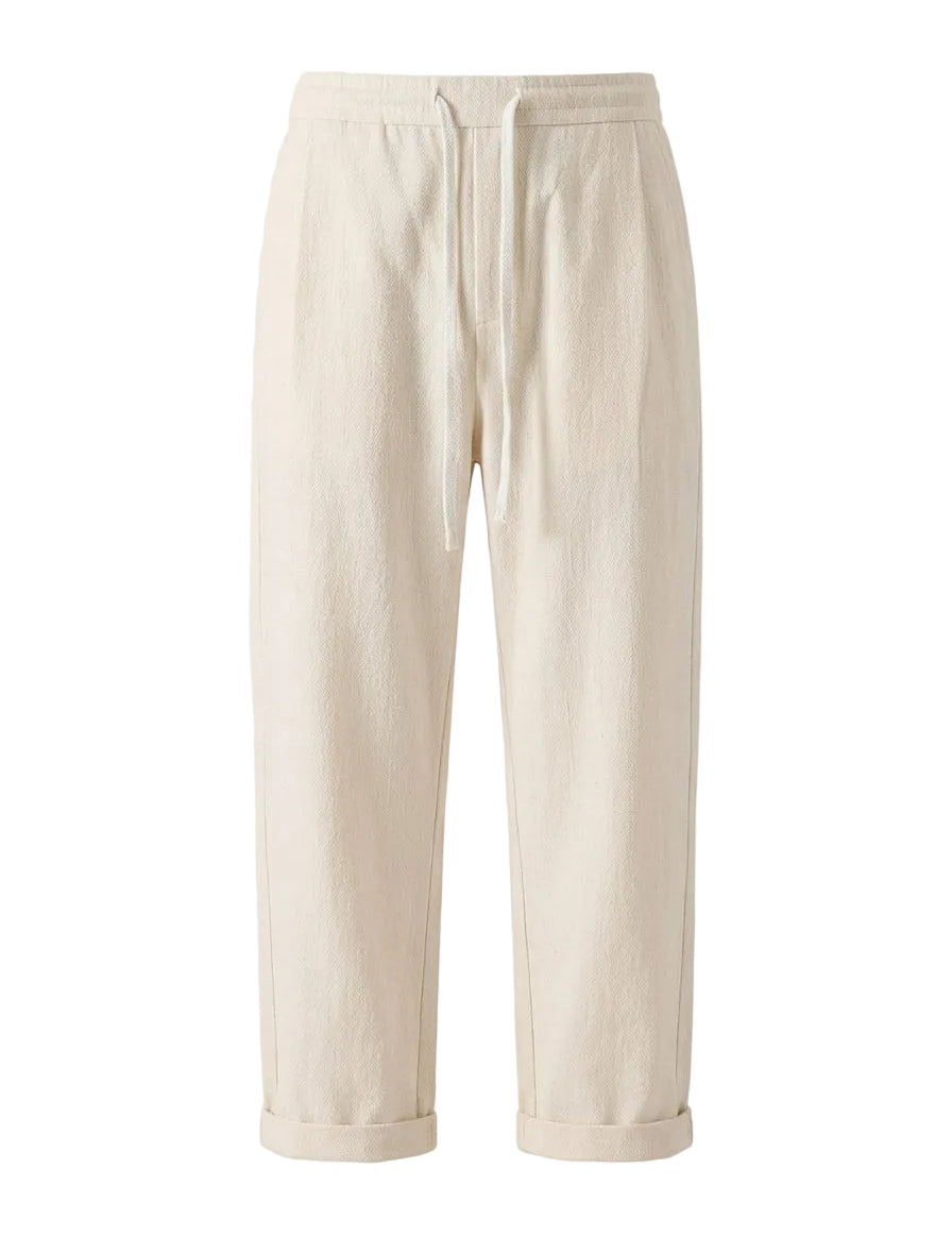 Cream drawstring jogger pants with tapered legs on a white background.