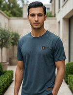 Front view of male model wearing a dark teal blue short-sleeve T-shirt with a relaxed casual fit.