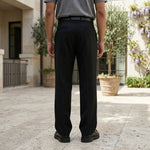 Full front view of male model wearing black pleated pants with a gray T-shirt.
