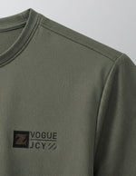 Green long-sleeve shirt with a logo on a gray background