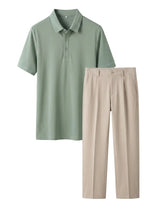 Green polo shirt and beige pants on a light gray background