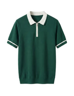 Green polo shirt with white collar and trim on a light gray background