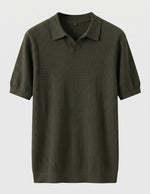 Green ribbed polo shirt on a light gray background