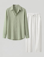 Green striped shirt and white pants on a light gray background
