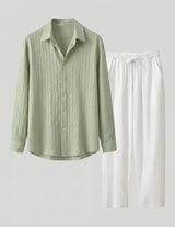 Green striped shirt and white pants on a light gray background