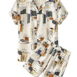 Ivory abstract print short-sleeve button-up shirt with matching summer shorts arranged on a white background.