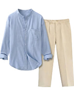Light blue button-up shirt and beige pants on a light gray background