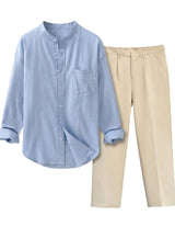 Light blue button-up shirt and beige pants on a light gray background