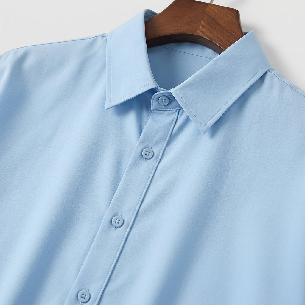 Light blue shirt on a wooden hanger against a white background