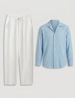 Light blue striped shirt and white pants on a light gray background