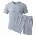 Light blue textured short-sleeve T-shirt with matching drawstring shorts on a white background.