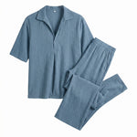 Light blue textured short-sleeve shirt with matching straight-leg pants on a white background.