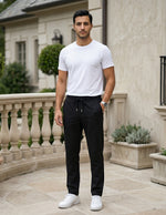 Man wearing a black men’s lightweight drawstring pants with elastic waistband and clean casual fit