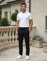 Man wearing a black men’s lightweight drawstring pants with elastic waistband and clean casual fit