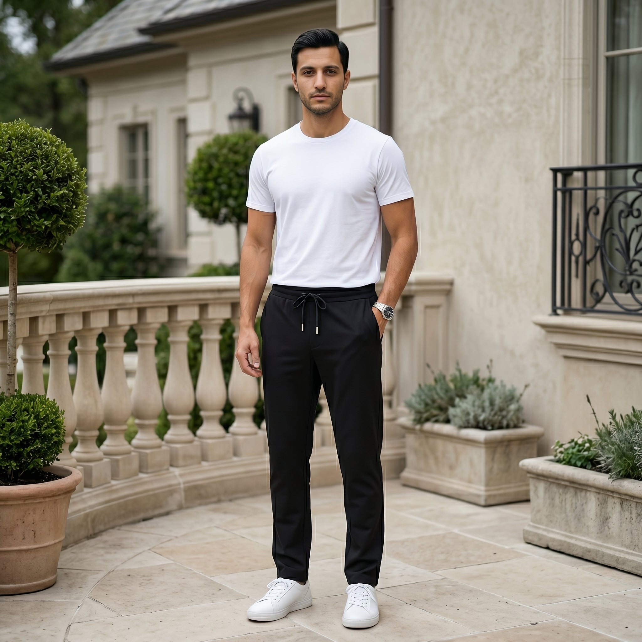 Man wearing a black men’s lightweight drawstring pants with elastic waistband and clean casual fit