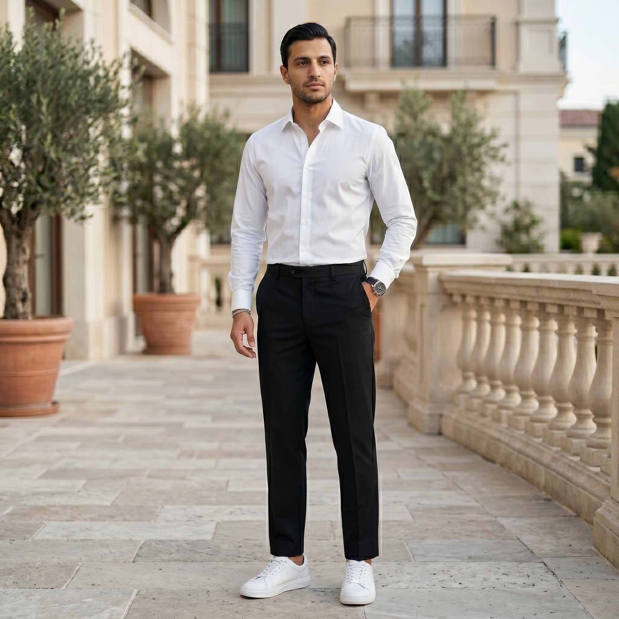 Man wearing a black men’s pleated tailored pants with clean front closure and straight fit