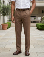 Man wearing a brown men’s pleated pocketed trousers with button waistband bottom