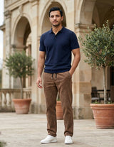 Man wearing a brown men’s ribbed drawstring pants with elastic waistband and side pockets