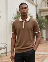 Man wearing a brown short-sleeve sweater with white trim in an outdoor setting.