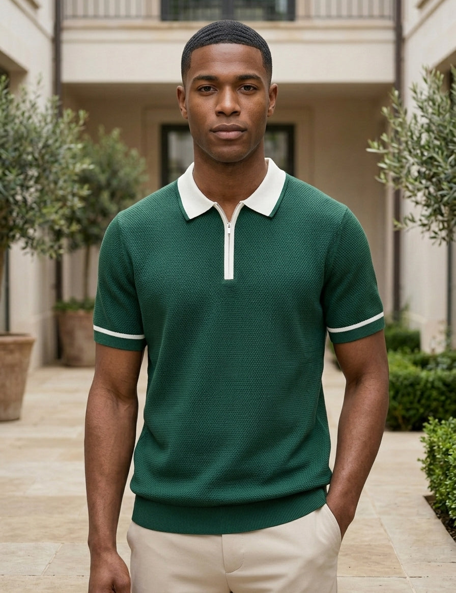 Man wearing a green polo shirt with white trim standing outdoors.